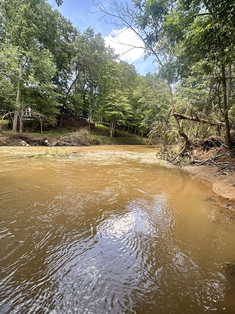 A muddied, swift-moving Eno River, more than a week after tropical depression Chantal unleashed historic flooding in Hillsborough.