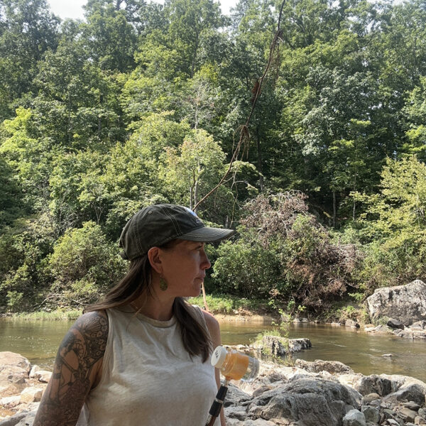 Neuse Riverkeeper Samantha Krop collects a water sample at one of five sites along the Eno River.