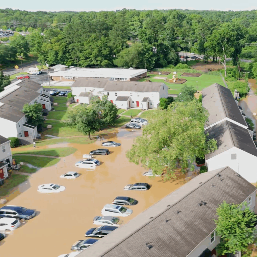 Aerial photo of a neighborhood adjacent to the Eno River flooded with brown water
