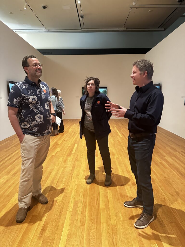 Ryan Fehrman, Heather McIntyre, and Trevor Schoonmaker chatting in Dyani White Hawk's LISTEN Exhibit of Indigenous Spoken Word Stories at the Nasher Museum of Art.